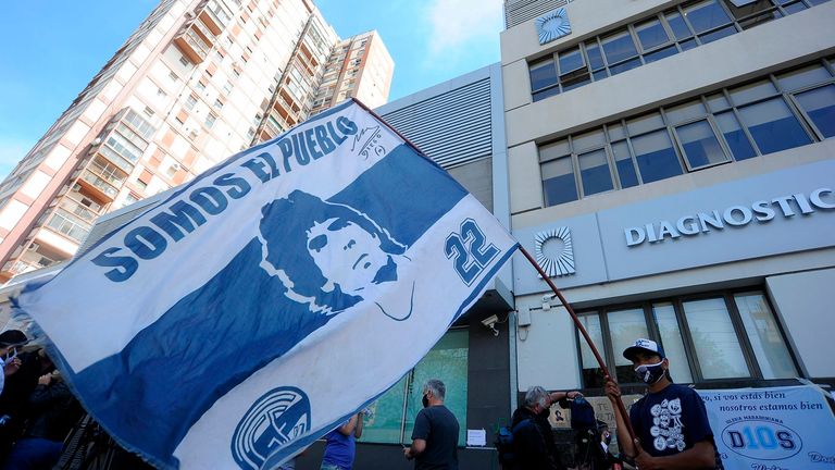 Supporters and well-wishers gather outside the private clinic where Diego Maradona underwent surgery