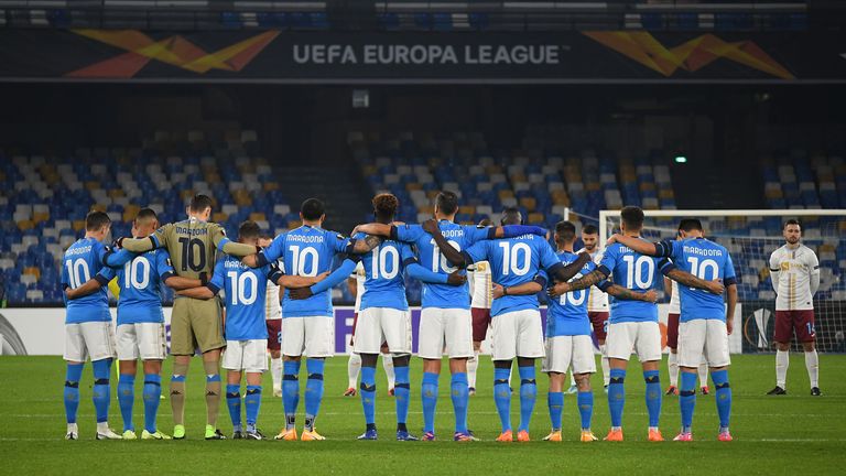 The Napoli players gather for a minute's silence before kick-off