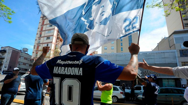 Supporters of Argentina's Gimnasia y Esgrima La Plata gather outside the private clinic where Argentinian former soccer star Diego Maradona underwent brain surgery for a blood clot, in Olivos, Buenos Aires