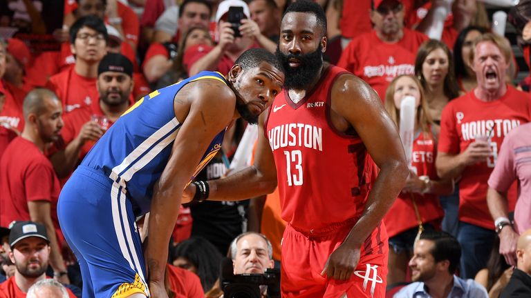 Kevin Durant of the Golden State Warriors and James Harden of the Houston Rockets look on during Game Three of the Western Conference Semifinals of the 2019 NBA Playoffs