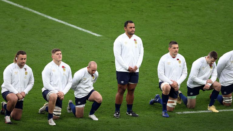 England's number 8 Billy Vunipola (C) stands as team mates take a knee in support of the Black Lives Matter movement 