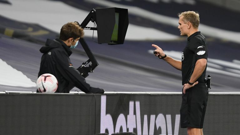 Referee Graham Scott checks for a foul in the build-up to Brighton&#39;s goal against Spurs