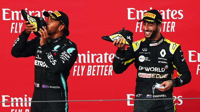 Daniel Ricciardo and Lewis Hamilton share a shoey