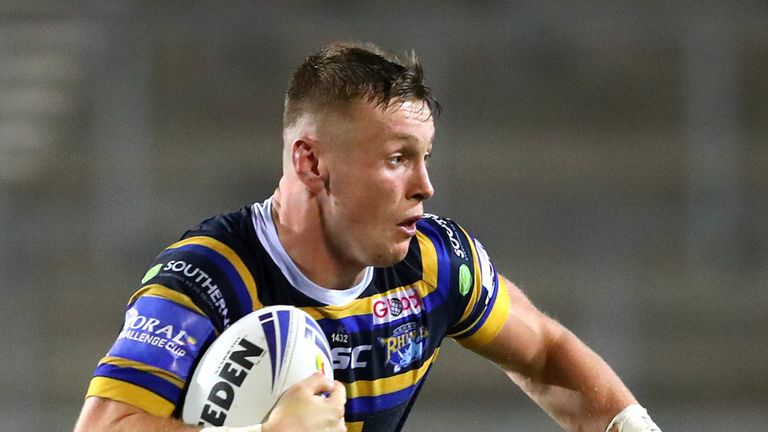 Harry Newman of Leeds Rhinos is tackled by Jamie Ellis of Hull Kingston Rovers during the Coral Challenge Cup Quarter Final match between Leeds Rhinos of Hull Kingston Rovers at Totally Wicked Stadium on September 18, 2020 in St Helens, England
