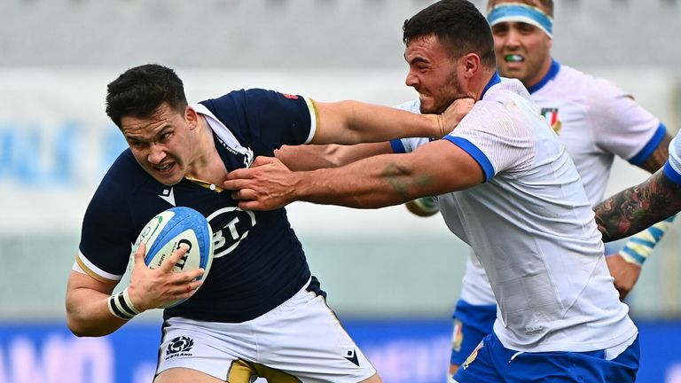 Italy's tighthead prop Giosue Zilocchi (C) tackles Scotland's centre Samuel Johnson 