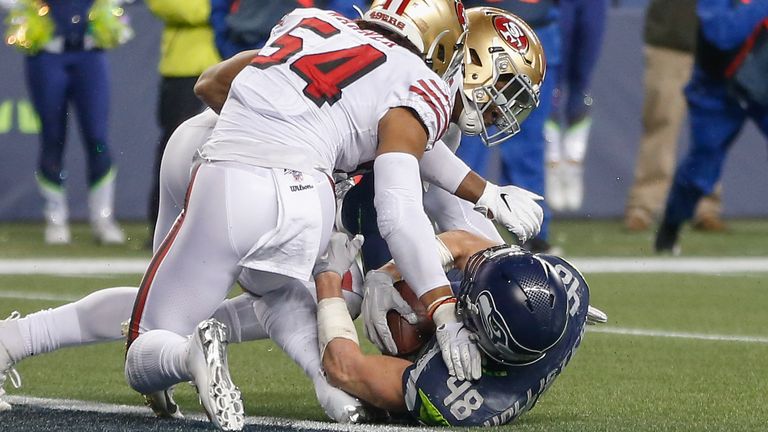 SEATTLE, WA - DECEMBER 29:  Tight end Jacob Hollister #48 of the Seattle Seahawks is stopped just short of the goal line by linebacker Dre Greenlaw #57 and linebacker Fred Warner #54 of the San Francisco 49ers in the fourth quarter at CenturyLink Field on December 29, 2019 in Seattle, Washington.  (Photo by Otto Greule Jr/Getty Images) *** Local Caption *** Jacob Hollister