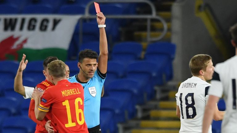 Jere Uronen of Finland receives a red card from referee, Jesus Gil Manzano against Wales