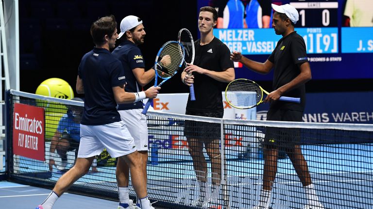 Austria's Jurgen Melzer (2nd L) and partner France's Edouard Roger-Vasselin (L) shake hands with USA's Rajeev Ram (R) and Britain's Joe Salisbury (2nd R) after their men's doubles semi-final match on day seven of the ATP World Tour Finals tennis tournament at the O2 Arena in London on November 21, 2020.