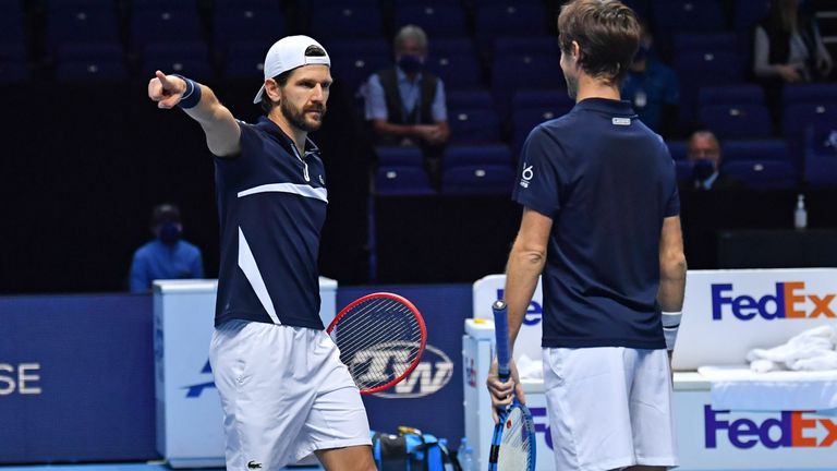 Austria's Jurgen Melzer (L) gestures as he celebrates with partner France's Edouard Roger-Vasselin after beating USA's Rajeev Ram and Britain's Joe Salisbury in their men's doubles semi-final match on day seven of the ATP World Tour Finals tennis tournament at the O2 Arena in London on November 21, 2020.