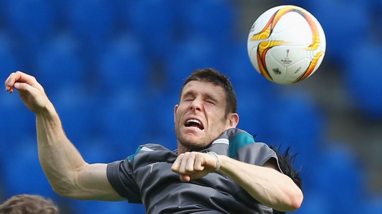 James Milner goes up for a header in Liverpool training.