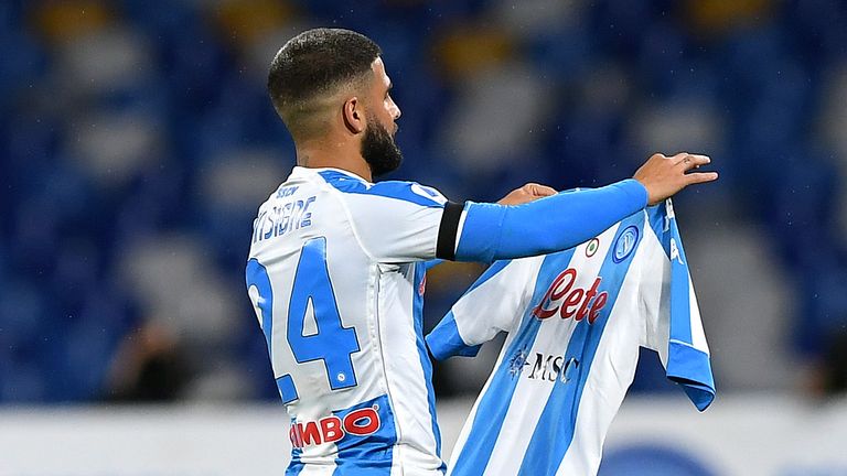 Lorenzo Insigne carries a blue and white striped Napoli shirt dedicated to the late Diego Maradona