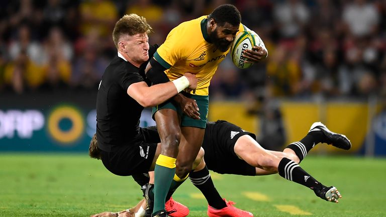 Marika Koroibete is wrapped up by the All Blacks defence