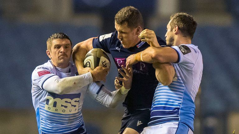 Edinburgh's Mark Bennett is tackled by Lewis Jones and Jason Tovey