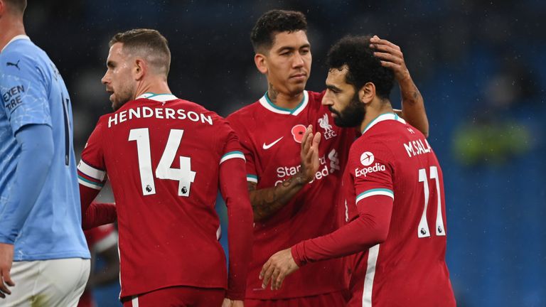 Mohamed Salah celebrates with team-mates Roberto Firmino and Jordan Henderson after giving Liverpool the lead