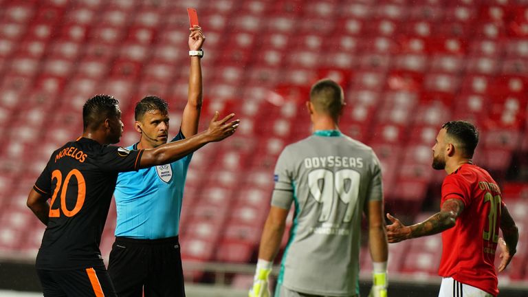 Benfica's Nicolas Otamendi is shown a red card against Rangers
