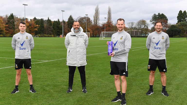 Nuno Espirito Santo accepts the October manager of the month award alongside his coaching staff