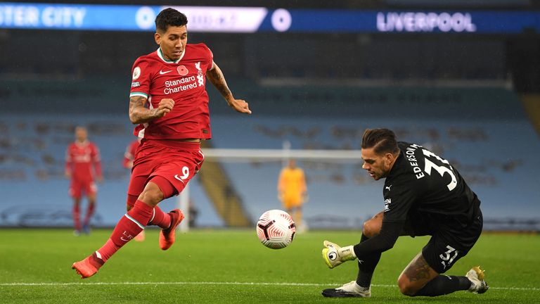 Roberto Firmino attempts to dribble round Ederson