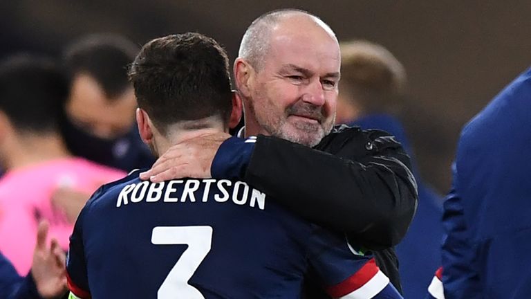  Steve Clarke (centre right) embraces Scotland's defender Andrew Robertson (centre left) on the pitch after Scotland win the penalty shoot-out during the Euro 2020 playoff semi-final football match between Scotland and Israel at Hampden Park, Glasgow on October 8, 2020. - Scotland won the penalty shoot-out 5-3 after the game finished 0-0 after extra time