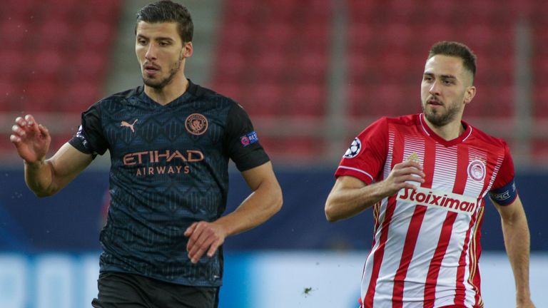 Ruben Dias is challenged by Kostas Fortounis of Olympiakos