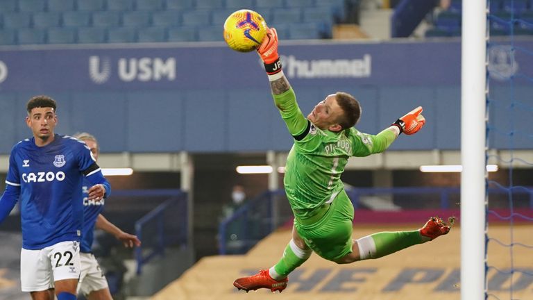 Everton goalkeeper Jordan Pickford saves a shot from Leeds United's Raphinha