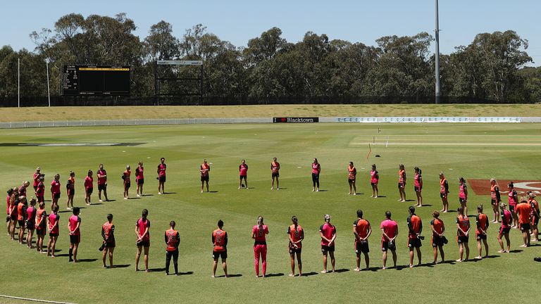 Scorchers and Sixers players form a barefoot circle before the Women's Big Bash League WBBL match between the Perth Scorchers and the Sydney Sixers at Blacktown International Sportspark, on November 11, 2020, in Sydney, Australia. (Photo by Mark Metcalfe/Getty Images)