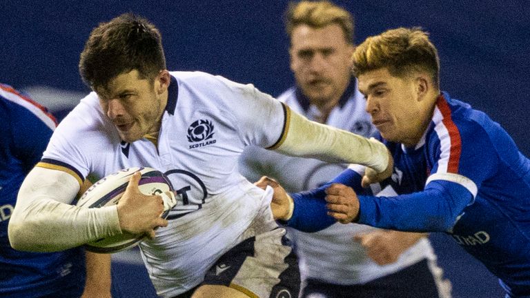 Scotland's Blair Kinghorn makes a break under pressure from France's Matthieu Jalibert