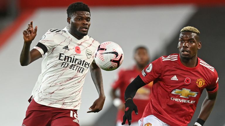 Thomas Partey and Paul Pogba in Premier League action at Old Trafford