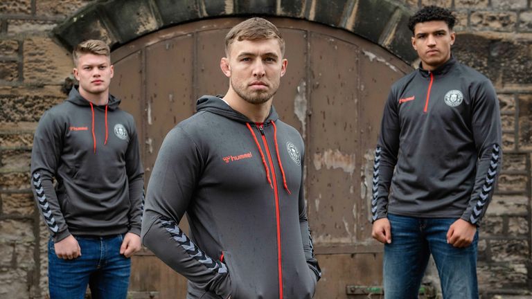 Morgan Smithies, Sam Powell and Kai Pearce-Paul in the Wigan leisurewear range featuring the new logo