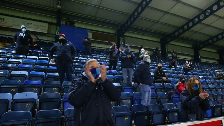 Socially distanced fans applaud as the team warm up prior to the Sky Bet Championship match between Wycombe Wanderers and Stoke City at Adams Park 