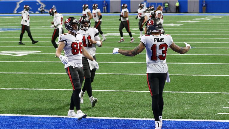 Wide receiver Mike Evans scored two touchdowns for Tampa Bay as the Buccaneers outclassed the Detroit Lions to reach the playoffs.