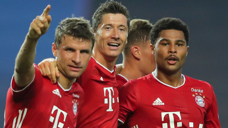 Bayern's Serge Gnabry, right, celebrates his side's second goal with teammates Robert Lewandowski, center, and Thomas Mueller during the Champions League semifinal soccer match between Lyon and Bayern Munich at the Jose Alvalade stadium in Lisbon, Portugal, Wednesday, Aug. 19, 2020. (Miguel A. Lopes/Pool via AP)