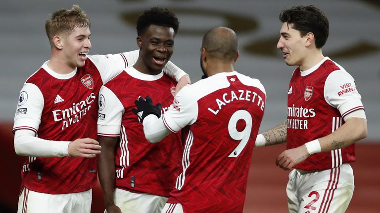 Arsenal's Bukayo Saka (second left) celebrates scoring his side's third goal of the game