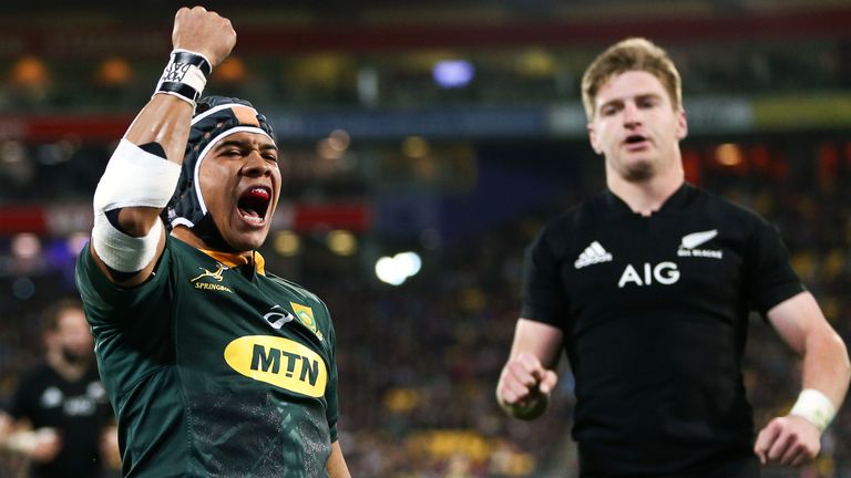 WELLINGTON, NEW ZEALAND - SEPTEMBER 15: Cheslin Kolbe of South Africa celebrates after scoring a try while Jordie Barrett of New Zealand looks on during The Rugby Championship match between the New Zealand All Blacks and the South Africa Springboks at Westpac Stadium on September 15, 2018 in Wellington, New Zealand. (Photo by Hagen Hopkins/Getty Images)