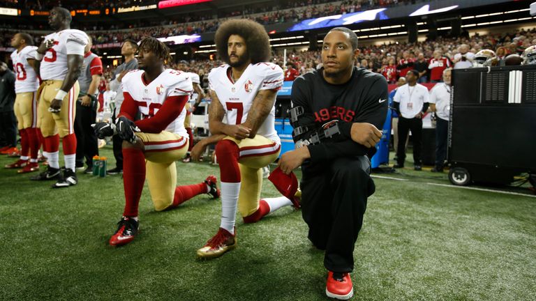 Eli Harold #58, Colin Kaepernick #7 and Eric Reid #35 of the San Francisco 49ers kneel on the sideline, during the anthem, prior to the game against the Atlanta Falcons at the Georgia Dome on December 18, 2016 in Atlanta, Georgia. The Falcons defeated the 49ers 41-13. (Photo by Michael Zagaris/San Francisco 49ers/Getty Images)  *** Local Caption *** Eli Harold;Colin Kaepernick;Eric Reid