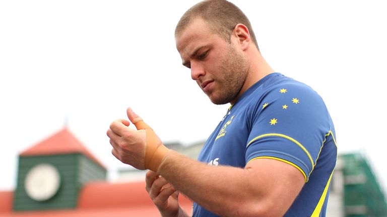 SYDNEY, AUSTRALIA - JUNE 21: Dan Palmer of the Wallabies tapes up his wrists during an Australian Wallabies training session at Coogee Oval on June 21, 2012 in Sydney, Australia. (Photo by Cameron Spencer/Getty Images)
