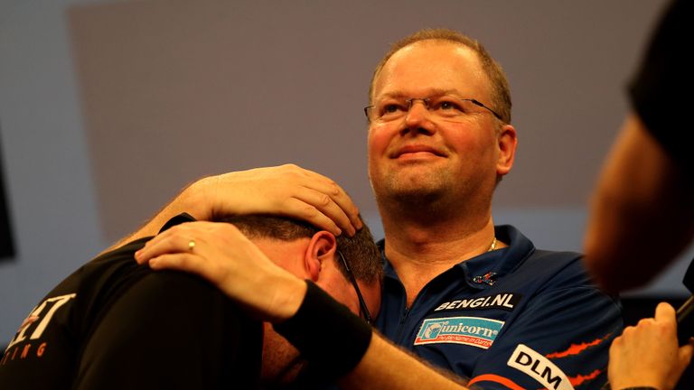 Raymond van Barneveld of the Netherlands embraces Stephen Bunting of England following their quarter final match on day twelve of the 2015 William Hill PDC World Darts Championships at Alexandra Palace on January 2, 2015 in London, England. 