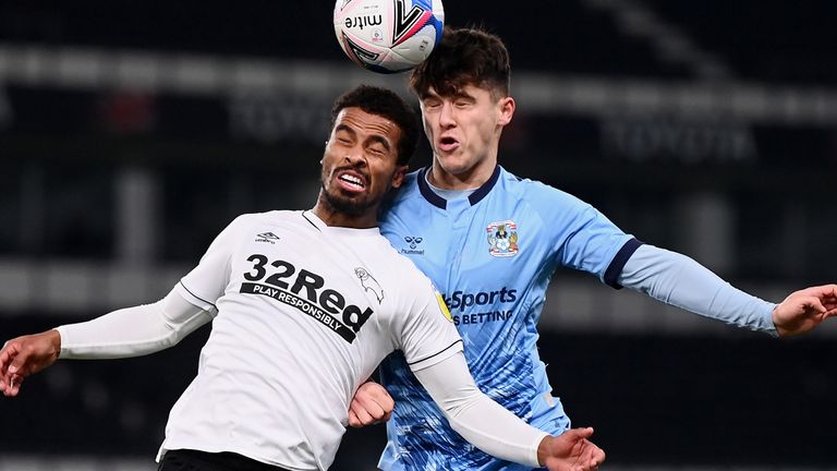 Nathan Byrne of Derby County battles for a header with Ryan Giles of Coventry City