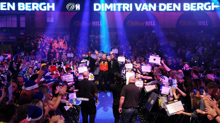 Dimitri Van den Bergh makes his entrance at the World Darts Championship last year