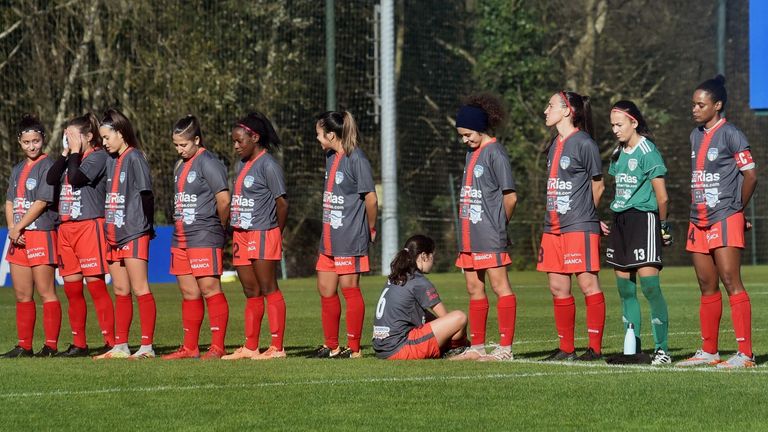 Paula Depena (seated) faces away from her team mates in protest over a minute's silence for Diego Maradona