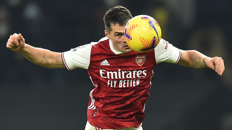 Granit Xhaka heads a ball clear during the north London derby