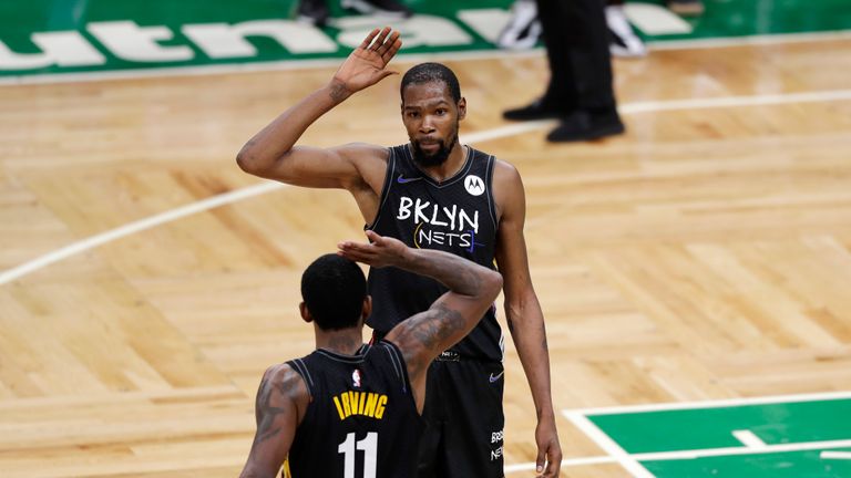 Kevin Durant #7 and Kyrie Irving #11 of the Brooklyn Nets high-five during the fourth quarter of the game against the Boston Celtics at TD Garden on December 25, 2020