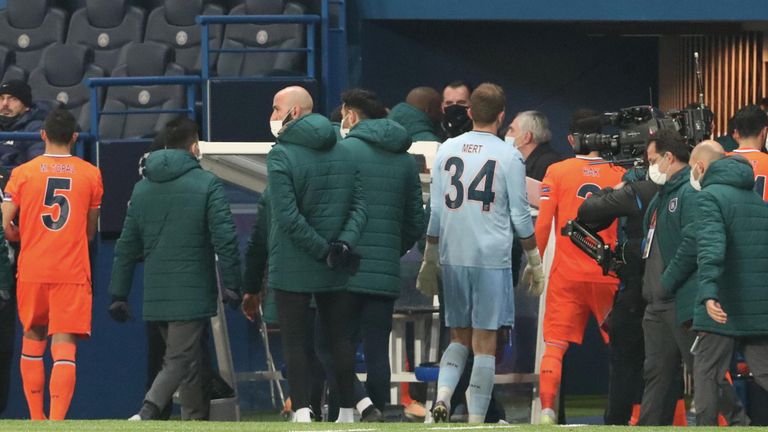 Players leave the field following an alleged incident between Istanbul Basaksehir assistant manager Pierre Achille Webo and the 4th official 