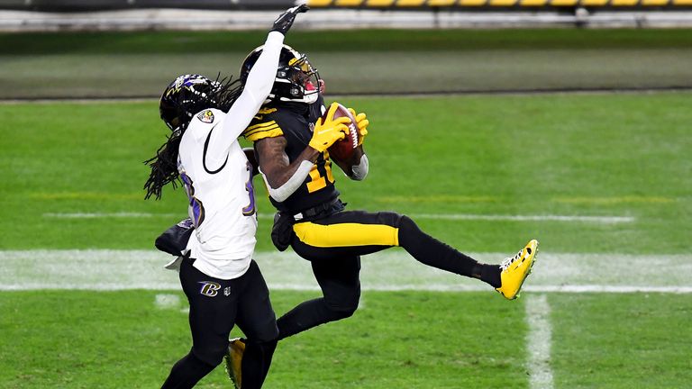 Diontae Johnson of the Pittsburgh Steelers makes a reception over Davontae Harris of the Baltimore Ravens 