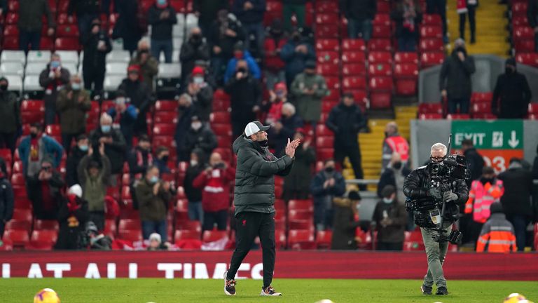 Jurgen Klopp applauds the Liverpool supporters at full time