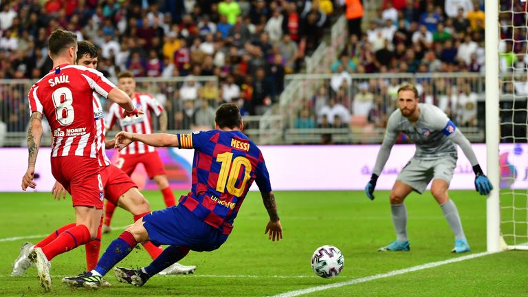 Atletico Madrid's Slovenian goalkeeper Jan Oblak (R) watches as Atletico Madrid's Spanish midfielder Saul Niguez (L) marks Barcelona's Argentine forward Lionel Messi (C) during the Spanish Super Cup semi final between Barcelona and Atletico Madrid on January 9, 2020, at the King Abdullah Sport City in the Saudi Arabian port city of Jeddah