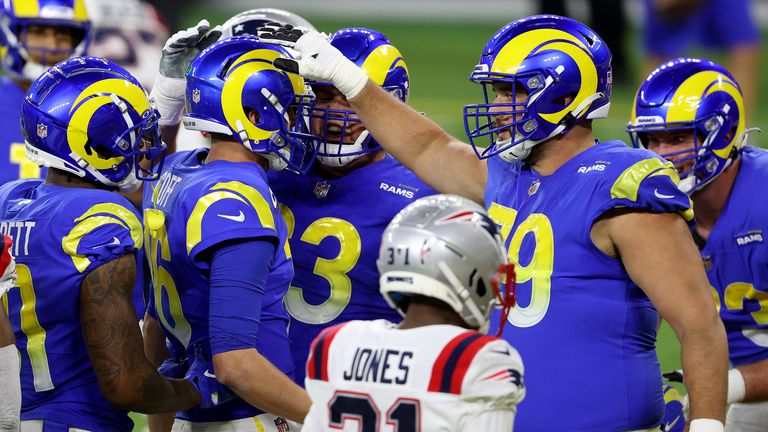 Teammates congratulate Jared Goff of the Los Angeles Rams (C) after scoring a touchdown against the New England Patriots