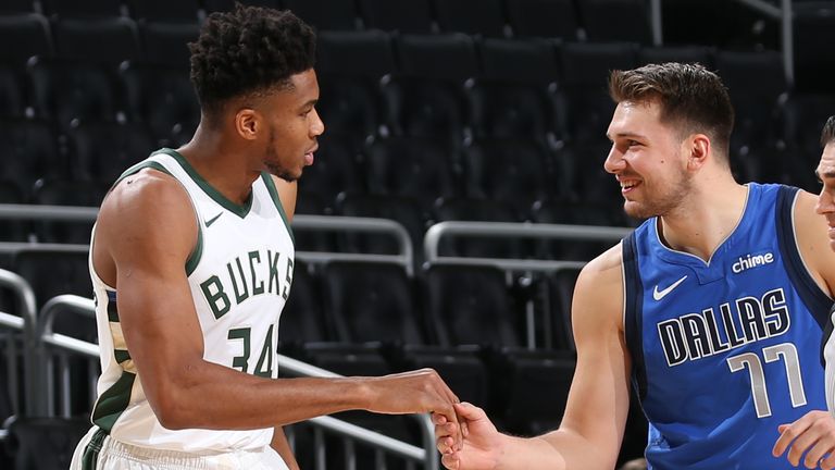 Giannis Antetokounmpo of the Milwaukee Bucks shakes hands with Luka Doncic of the Dallas Mavericks