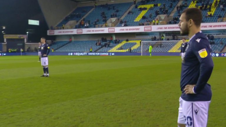 Millwall players stand when QPR players take the knee ahead of their Championship match.