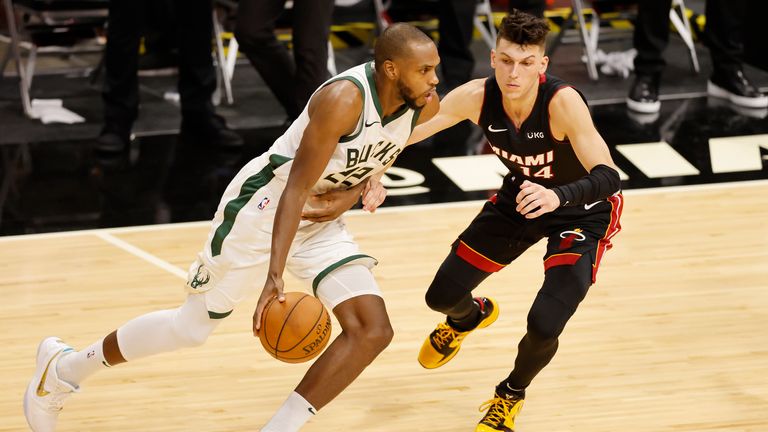Khris Middleton #22 of the Milwaukee Bucks drives against Tyler Herro #14 of the Miami Heat during the second quarter at American Airlines Arena on December 29, 2020 in Miami, Florida.