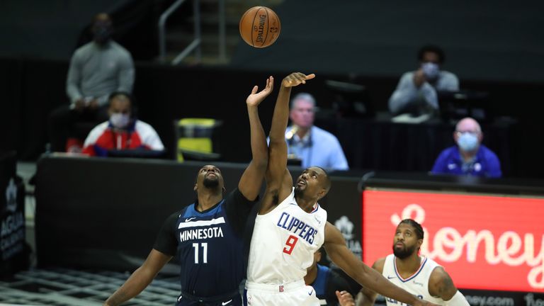 Naz Reid #11 of the Minnesota Timberwolves tips off against Serge Ibaka #9 of the LA Clippers during the first half of a game at Staples Center on December 29, 2020 in Los Angeles, California.